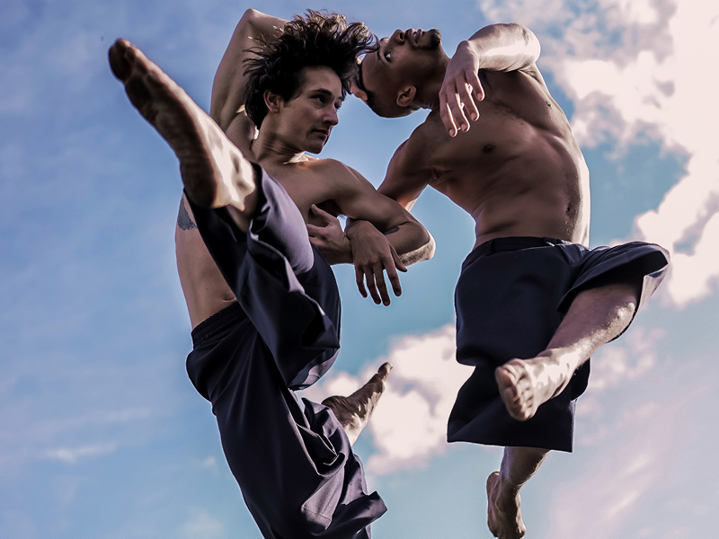 Two performers dancing outside