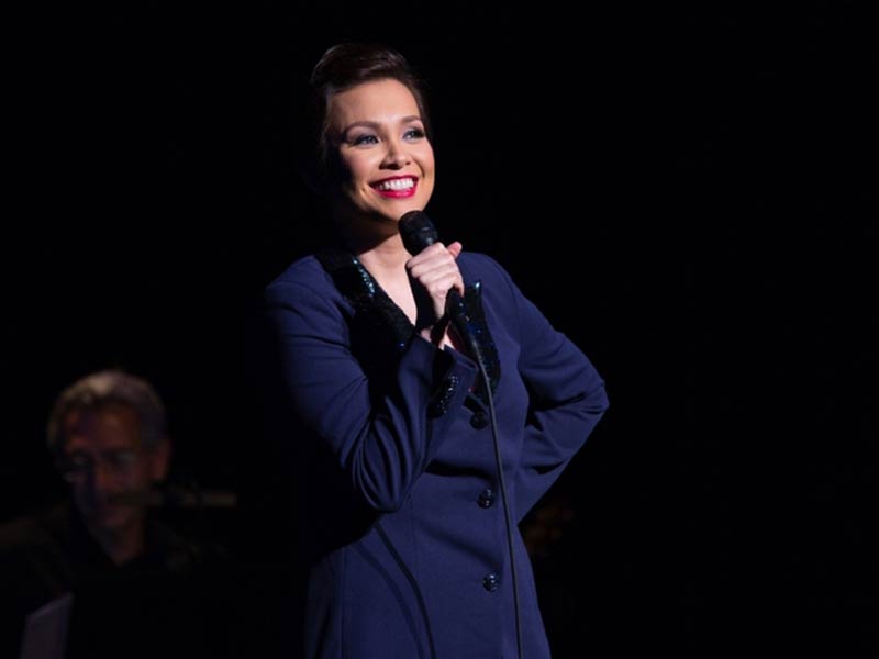 Lea Salonga performing with a microphone in hand