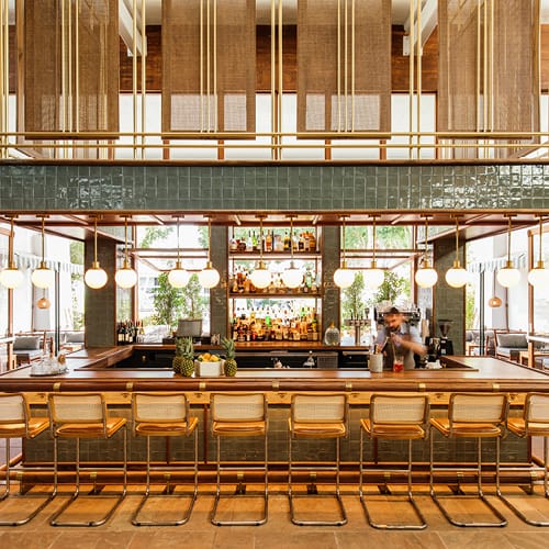 A bar at a restaurant with decorated interior