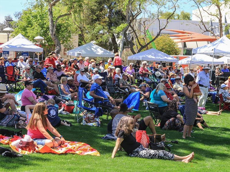 Large group of people in a park for a festival